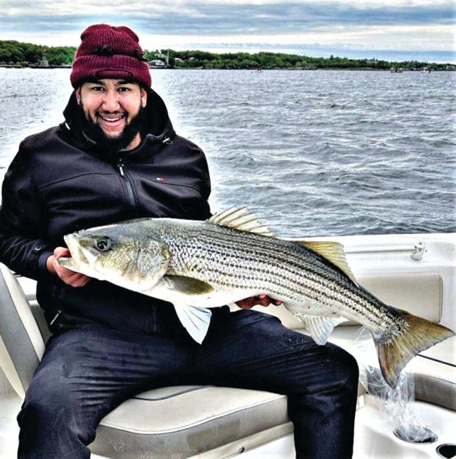 WHAT’S THE CATCH: Leo Beras of Providence with a striped bass caught last week in the East Passage of Narragansett Bay.